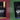 Split-screen VS graphic comparing a bag of Decaf Low Country tea on a burgundy background with a bag of Nightfall herbal tea on a green background